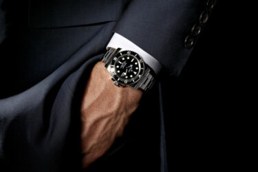 Man wearing watch with hand in his pocket