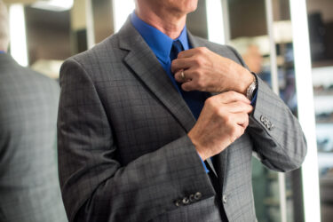 Man in Suit wearing a watch on his left hand